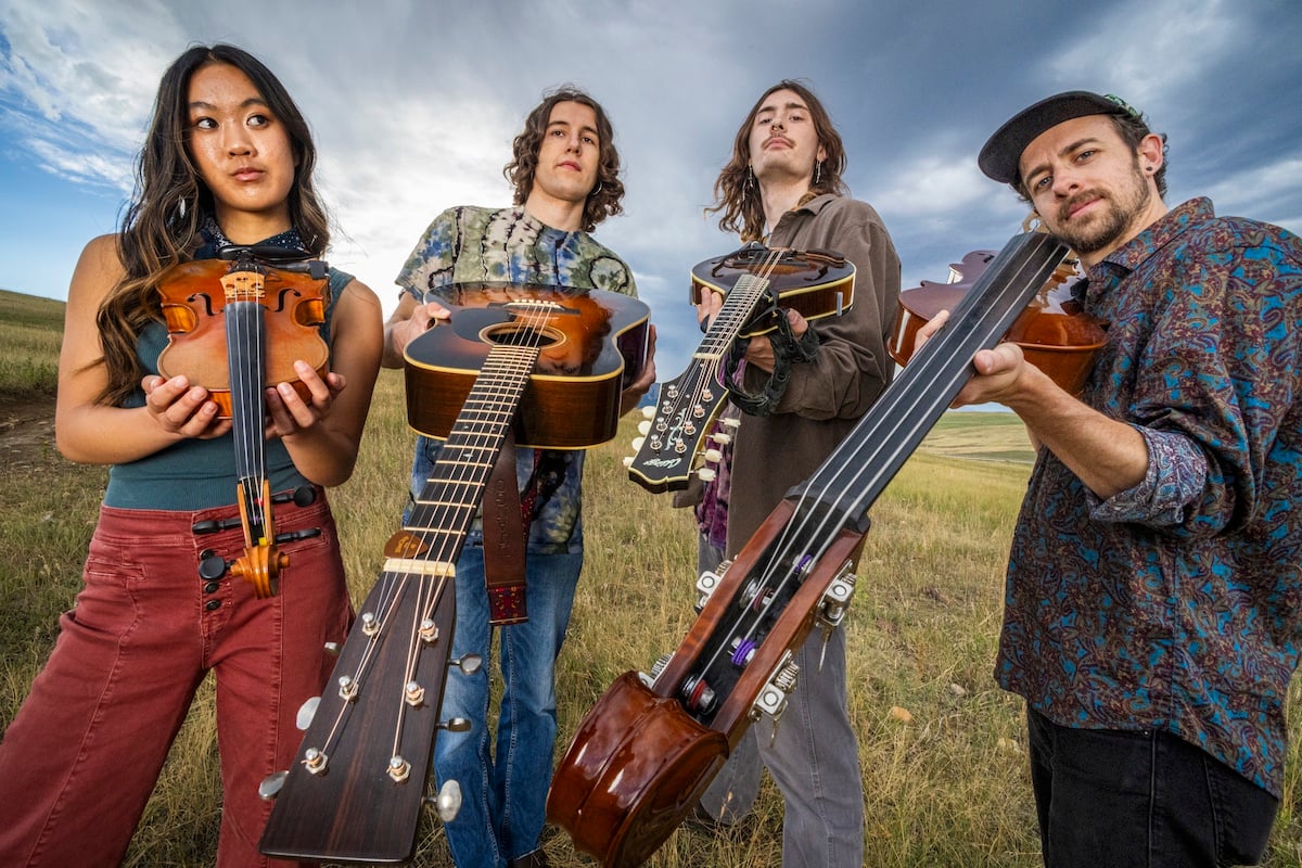 BrokenCompass-1200.jpg A group of people holding musical instruments.