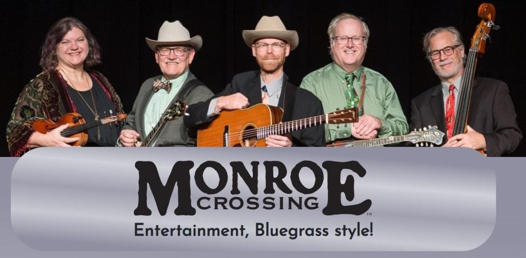 Five musicians with string instruments pose together behind a banner that reads, "Monroe Crossing: Entertainment, Bluegrass style!.