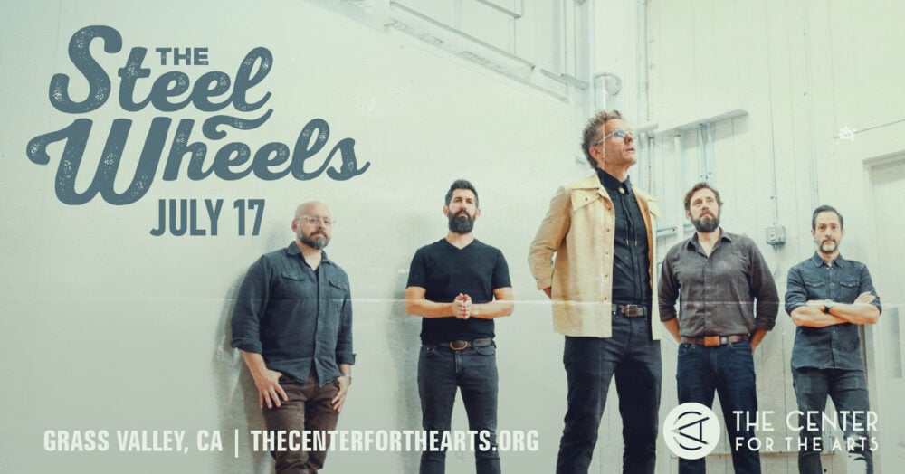 Five men stand indoors against a white wall under the text “The Steel Wheels July 17”; event details for The Center for the Arts in Grass Valley, CA appear at the bottom.