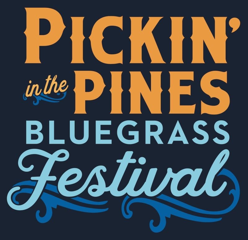 Pickin’ in the Pines Bluegrass Festival logo with stylized orange and blue text on a dark background.
